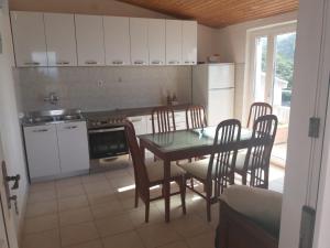 a kitchen with a table and chairs and a stove at Boni02 in Gdinj