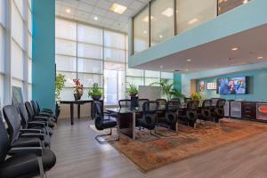 a waiting room with chairs and a flat screen tv at Downtown 2br w pool gym wd nr Convention Center LAX-1039 in Los Angeles