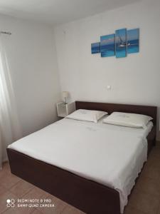 a bed in a room with two pillows on it at Boni02 in Gdinj