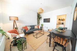 a living room with a couch and a table at Kandaka-Peaceful House in Roundhay