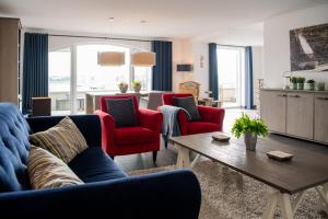 a living room with a couch and chairs and a table at Appartement in Zeeland - Kabbelaarsbank 515 - Port Marina Zélande - Ouddorp - not for companies in Ouddorp