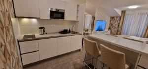 a kitchen with white cabinets and a counter top at Carice Milice Old Town Residence Self Check-in in Belgrade