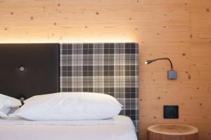 Postel nebo postele na pokoji v ubytování Hotel Piccola Baita