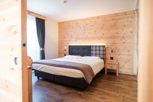 Postel nebo postele na pokoji v ubytování Hotel Piccola Baita