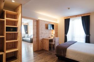 Postel nebo postele na pokoji v ubytování Hotel Piccola Baita