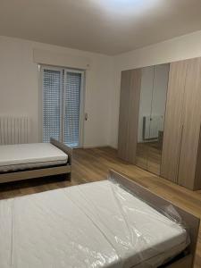 a bedroom with two beds and a large mirror at La casa dello zio in Vasto