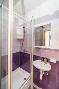 a bathroom with a sink and a shower at Studio and Rooms Zadar City Wall in Zadar +18 photos