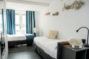 a bedroom with two beds and a window at Appartement in Zeeland - Kabbelaarsbank 515 - Port Marina Zélande - Ouddorp - not for companies in Ouddorp