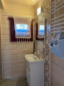 a bathroom with a white sink and a mirror at Apartamenty Beata w Sasinie in Sasino
