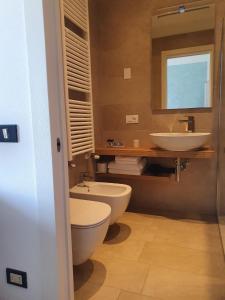 La salle de bains est pourvue de toilettes et d'un lavabo. dans l'établissement Hotel 2 Palme, à Torri del Benaco