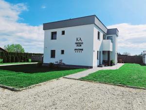 a white building with a sign on the side of it at Apartmani KA Sveti Martin in Sveti Martin na Muri