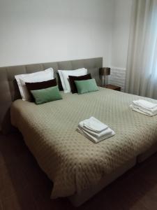 a bed with two towels on top of it at Moradia gémea 2 em Herdade Santa Marta in Zebreira