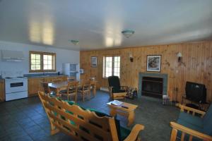 a living room with a kitchen and a dining room at Camp Taureau - Altaï Canada in Saint-Michel-des-Saints