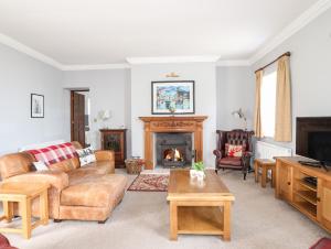 a living room with a couch and a fireplace at The Manor House in Holyhead