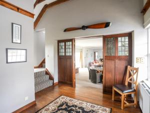 a living room with a ceiling fan above the door at The Manor House in Holyhead