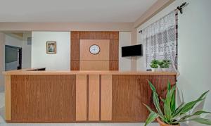 a reception desk with a clock in a room at Treebo Trend Staying Center in Shillong