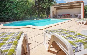 a swimming pool with two chairs and a table at Gorgeous Home In Bédarieux in Bédarieux