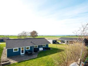 a blue house with a yard at 12 person holiday home in Vinderup in Vinderup