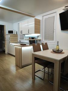 a kitchen with a table and chairs in a kitchen at SEA LUX FLOATING HOUSE AJDA Portorose in Portorož