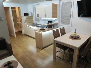 a small kitchen with a table and a dining room at SEA LUX FLOATING HOUSE AJDA Portorose in Portorož