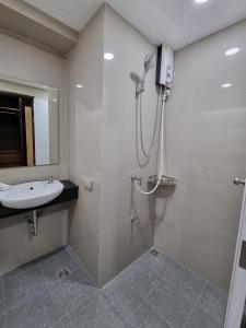 a bathroom with a shower and a sink at Tiara Place in Bangkok