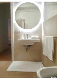a bathroom with a sink and a mirror at La Bella Vita in Cagliari +24 photos