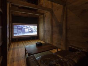 ein Wohnzimmer mit einem Sofa und einem Tisch in der Unterkunft Nipponia Izumo Hirata Cotton Road in Izumo