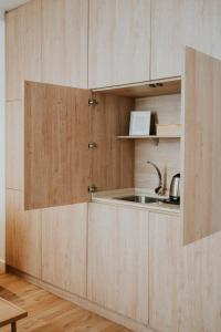 a kitchen with wooden cabinets and a sink at Rincon 13 - Mares in Torre del Mar