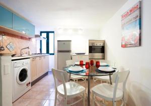 a kitchen with a table and chairs in a kitchen at La Tata home in Salerno
