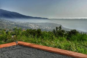 a view of a city and the ocean from a hill at La Finca de la bicicleta in Breña Alta
