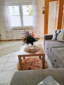 a living room with a vase of flowers on a table at Ferienhaus Kranichnest in Barth