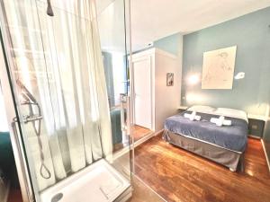 a bedroom with a bed and a glass shower at ApartHotel Riviera - Grimaldi Coeur de Ville - Large Studio AC with bigger South Terrace - Hyper Centre - TERRASSE ESPRIT in Nice