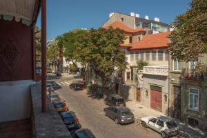 a street with cars parked on the side of the road at 57 in Porto