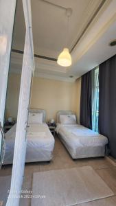 a bedroom with two beds and a light fixture at Pharaohs Inn Deira Hostel in Dubai