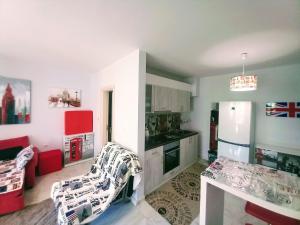 a kitchen with a table and a refrigerator and a counter at Luxury Apartments Artur in Sveti Vlas