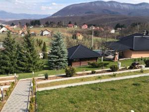 a view of a house with mountains in the background at Villa Elma in Sarajevo