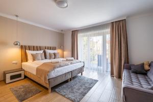 a bedroom with a large bed and a couch at Panorama Park in Świnoujście