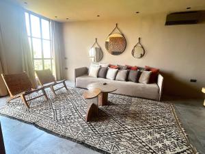 a living room with a couch and a table at Palais Souad in Marrakesh +80 photos