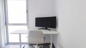A television and/or entertainment centre at MEDANO4YOU La Terraza Los Martines