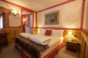 Postel nebo postele na pokoji v ubytování Hotel Bucaneve