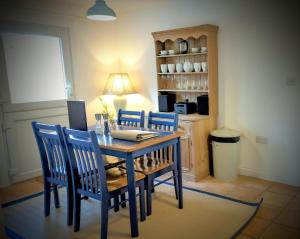 a dining room with a table and four chairs at Romantic Secluded Hideaway Cottage in Cornwall in Truro