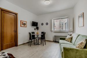 a living room with a couch and a table at Frezza's Holidays in Rome