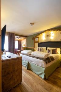 Postel nebo postele na pokoji v ubytování Hotel Bucaneve