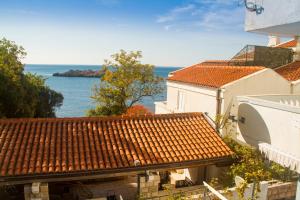 a view of the ocean from a building at Apartment San Stefan in Sveti Stefan
