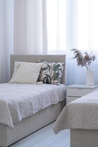 a bedroom with a bed with a pillow and a window at Apartament Green Lake - Mrągowo in Mrągowo