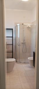 a bathroom with a shower and a toilet and a sink at La casina di Ale in Marina di Carrara +14 photos