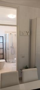 a bathroom with a shower and a toilet and a sink at La casina di Ale in Marina di Carrara