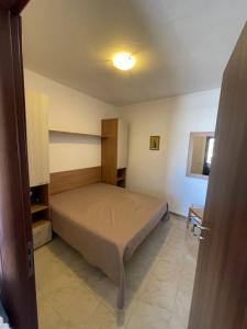 a bedroom with a bed in a room at Appartamenti Bella Vista in Lampedusa