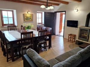 a dining room and living room with a table and chairs at Vacation House Donacka Gora in Rogatec