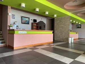 a lobby with a colorful counter in a building at Motel Ljetni raj in Baška Voda